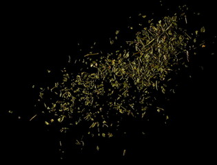 Chopped dry parsley leaves, pile isolated on black, top view - obrazy, fototapety, plakaty