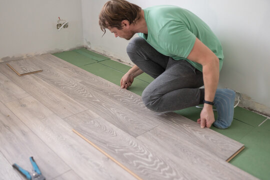 Man Laying Laminate Flooring