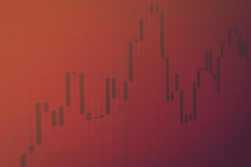 Financial market online chart on screen. Financial, business concept with a candle chart on a red background. Market price analysis