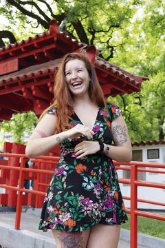 Red hair young woman smiling in the park