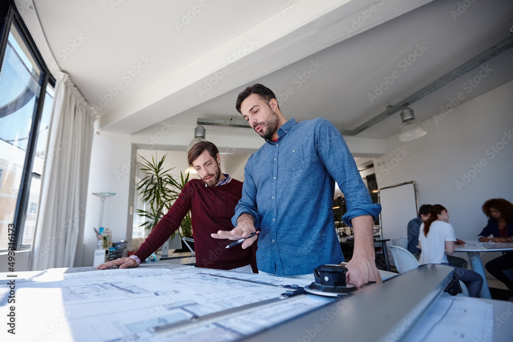 Poster heres what i have so far. shot of two architects looking at blueprints together in their office.