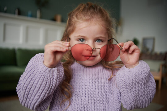 Cute toddler girl in narwhal shirt and funky glasses.