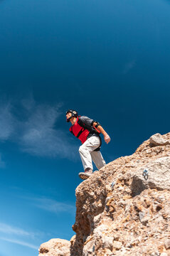 Extreme sportsman BASE jumping from mountain summit