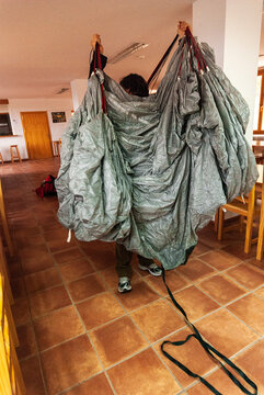 BASE jumper checking and assembling the parachute