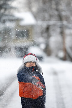 Little kid throwing snow