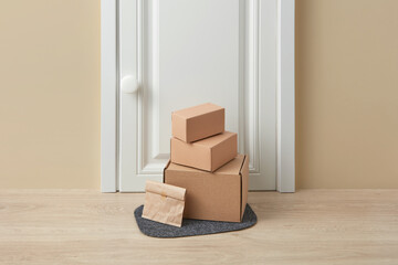 Cardboard parcel boxes delivered to white door