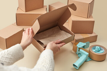 Close up of woman preparing boxes for online delivery