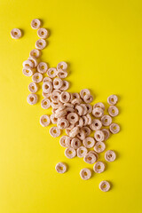 cereal for dry breakfast scattered on a yellow background