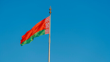 State flags of the Republic of Belarus are waving in the wind on blue sky background. Space for text.