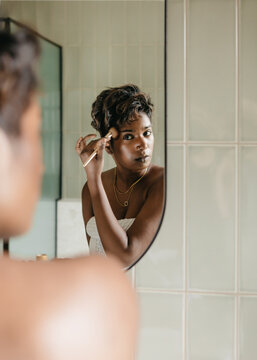 Young Australian woman applying make up with a brush