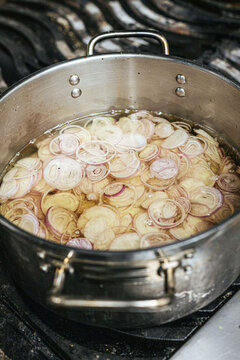 Shallots frying in a pot