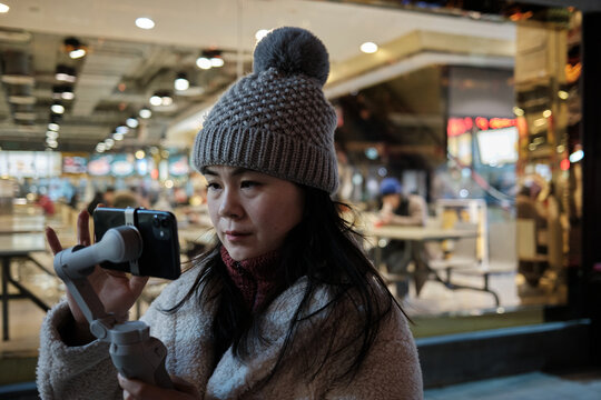 Chinese Woman Vlogs Using A Gimbal