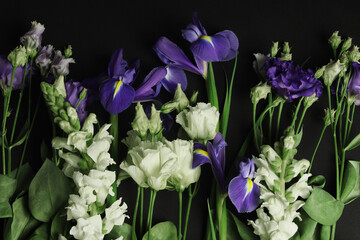 iris, lisianthus and snapdragon flowers on black background