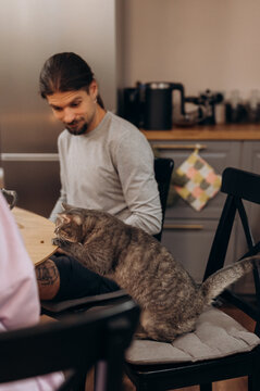 Man with curious car at kitchen table