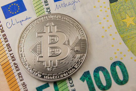 bitcoin on euro banknotes close-up - Powered by Adobe