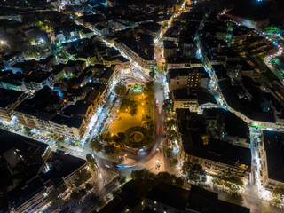 Panoramic aerial drone shot of the citylights of Corfu city at night. Kerkyra. Corfu island. Greece.