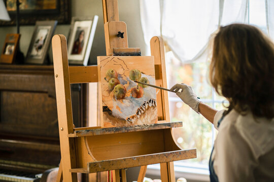 Oil painting artist painting still life in her studio.