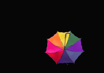 Multicolored rainbow umbrella isolated on black background