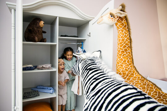 Little black  kids hiding in closet at home