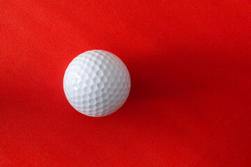 Golf ball on a red background