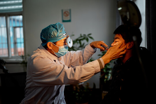 Doctor performing a test on a teenager at the hospital