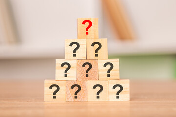 wooden cubes with question marks stacked