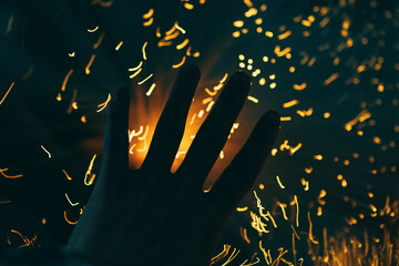 Multicolored lights in the room, a hand on a background of lights.