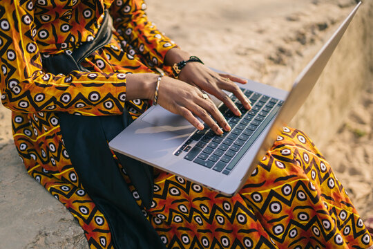 Crop Black Woman Using Laptop On Street