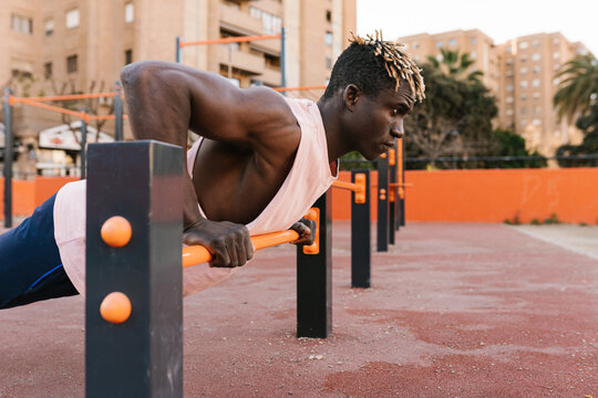 Confident African sportsman doing push ups in yard