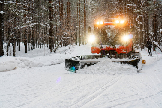 Snowcat combing skiing trail