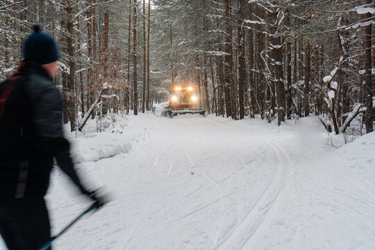 Snowcat combing skiing trail