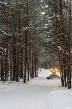 Snowcat combing skiing trail