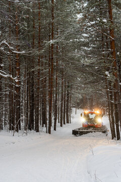 Snowcat combing skiing trail