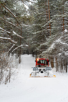 Snowcat combing skiing trail