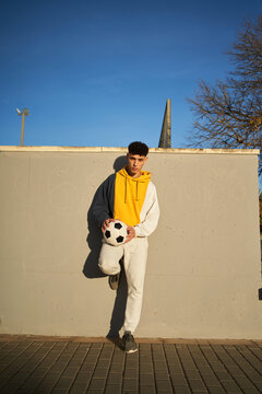 Serious man standing near concrete border