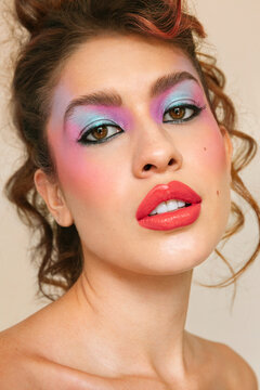 Young model with eighties make-up looking at the camera