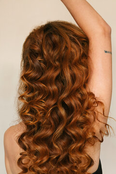 Back of a woman with curly hair