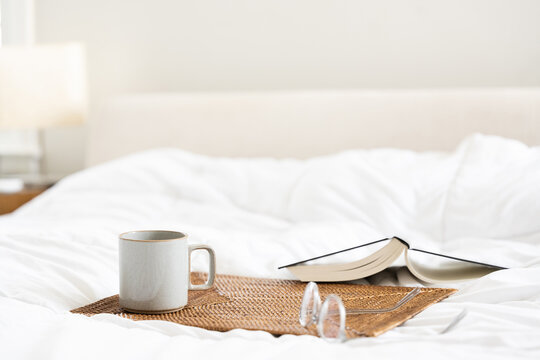 Coffee and book in bed - Powered by Adobe