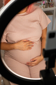 Pregnant woman holding her belly
