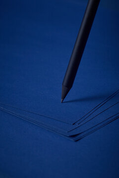 Black pencil on the blue paper