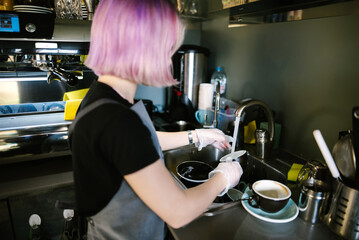 Barista washing coffee cup