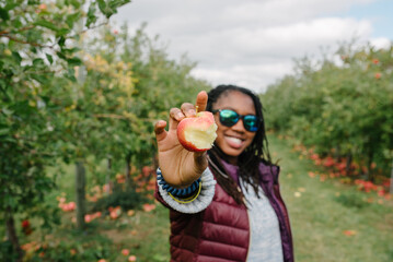 Smiling black girl holding an apple