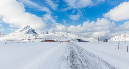 road to snow covered fjord peaks of the  Lofoten archipelago, Norway