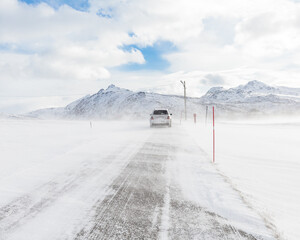 card driving through bad weather condition with heavy wind and snow 