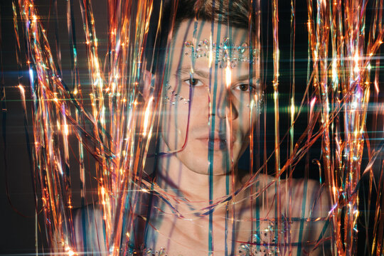 Closeup mans portrait with colorful tinsel