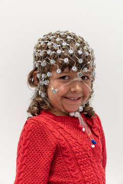 Portrait of a toddler in EEG cap in a lab