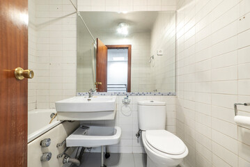 Bathroom with individual shower cabin, folding bidet and rectangular mirror embedded in the wall
