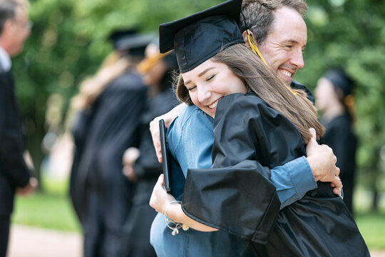 Grad: Proud Parent Hugs New Graduate