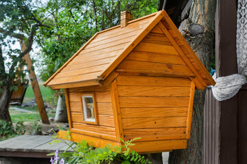 Back view of wooden birdhouse. Wooden hut for birds or small animals.
