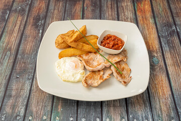 Grilled Pork Tenderloin Combo Plate with Fried Egg, Home Fries and Tomato Paste